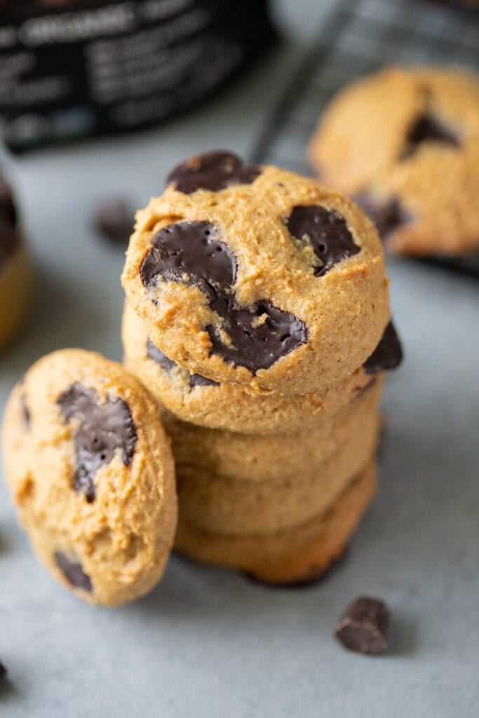 Healthy Chocolate Chip Cookies stacked on top of one another on a grey background