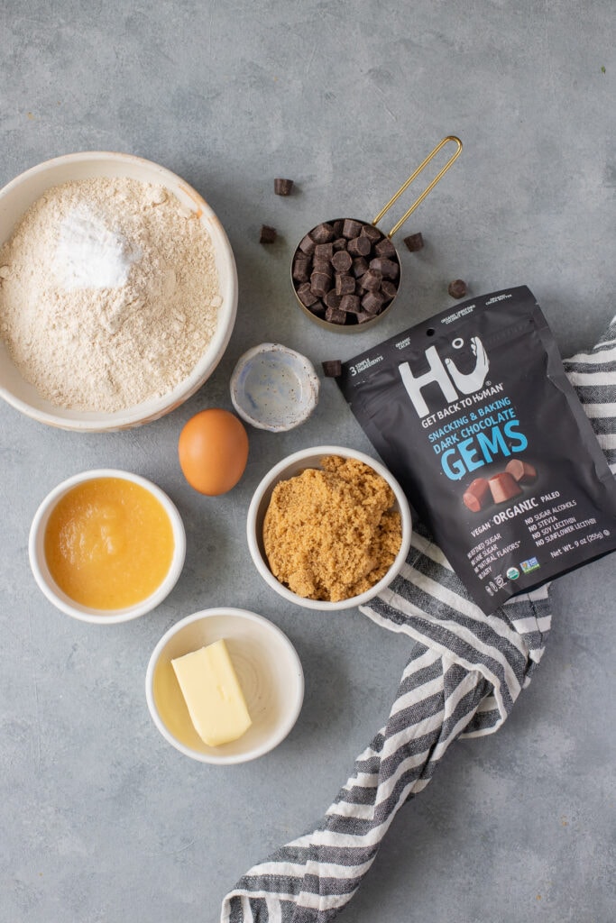 Ingredients for Whole Wheat Chocolate Chip Cookies in small white bowls on a grey background