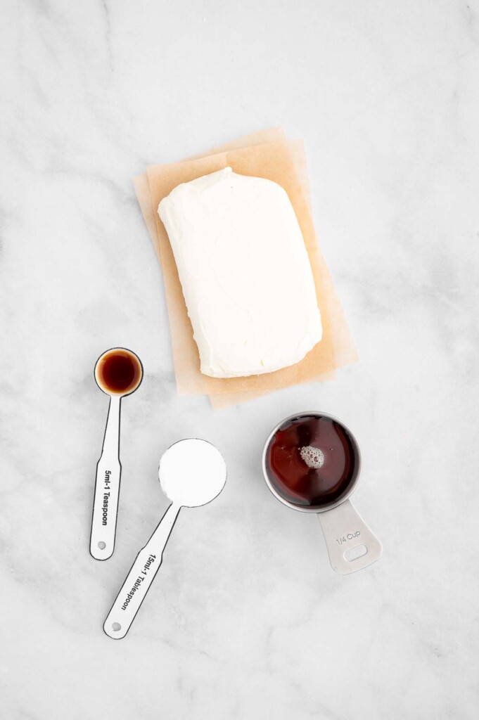 Ingredients for healthy cream cheese frosting on a white background: Neufchatel cheese, Greek Yogurt, Maple Syrup, Sea Salt