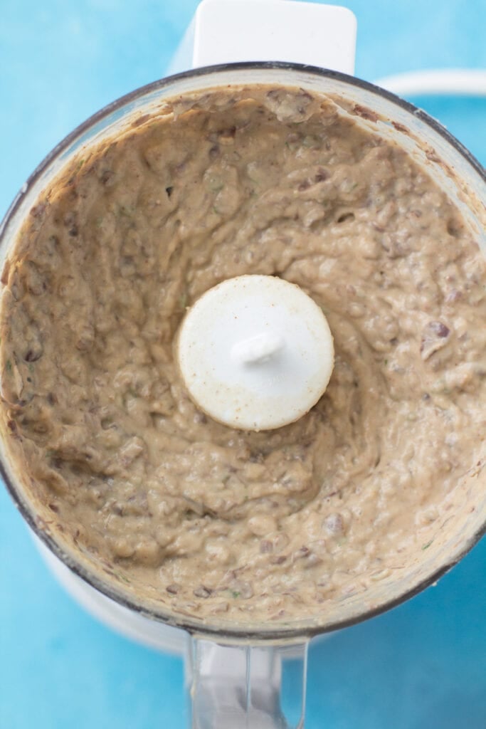 Bean dip in a food processor being blended together