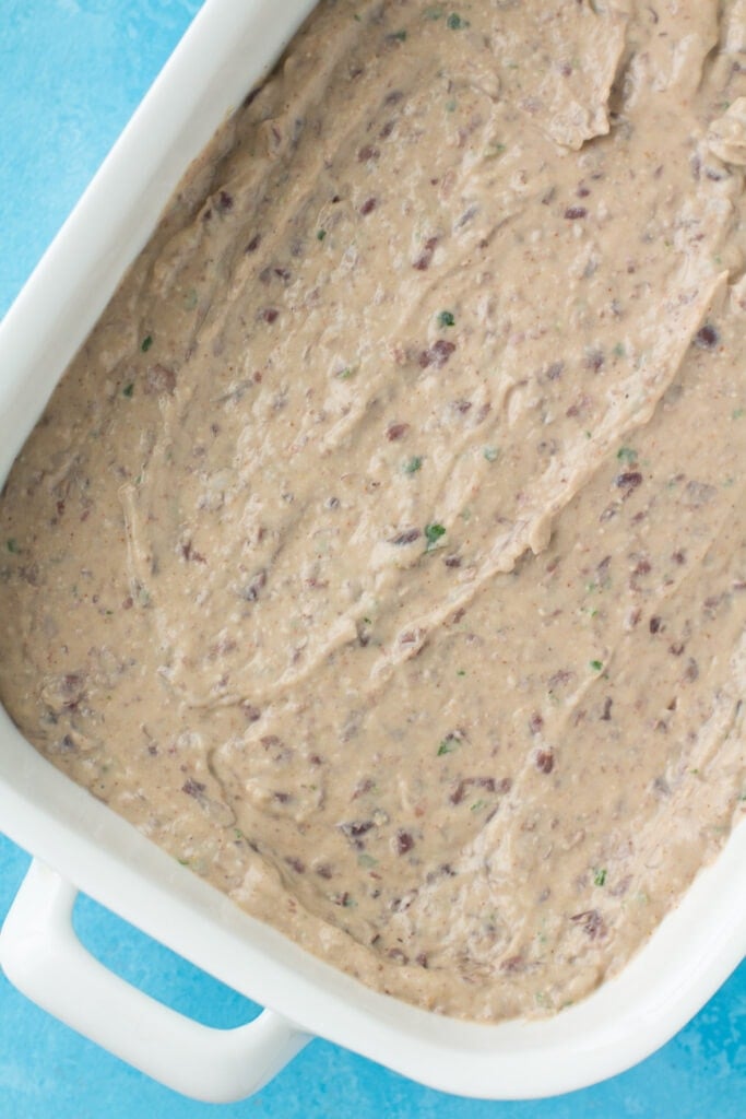 healthy bean dip in a white baking dish before going in the oven