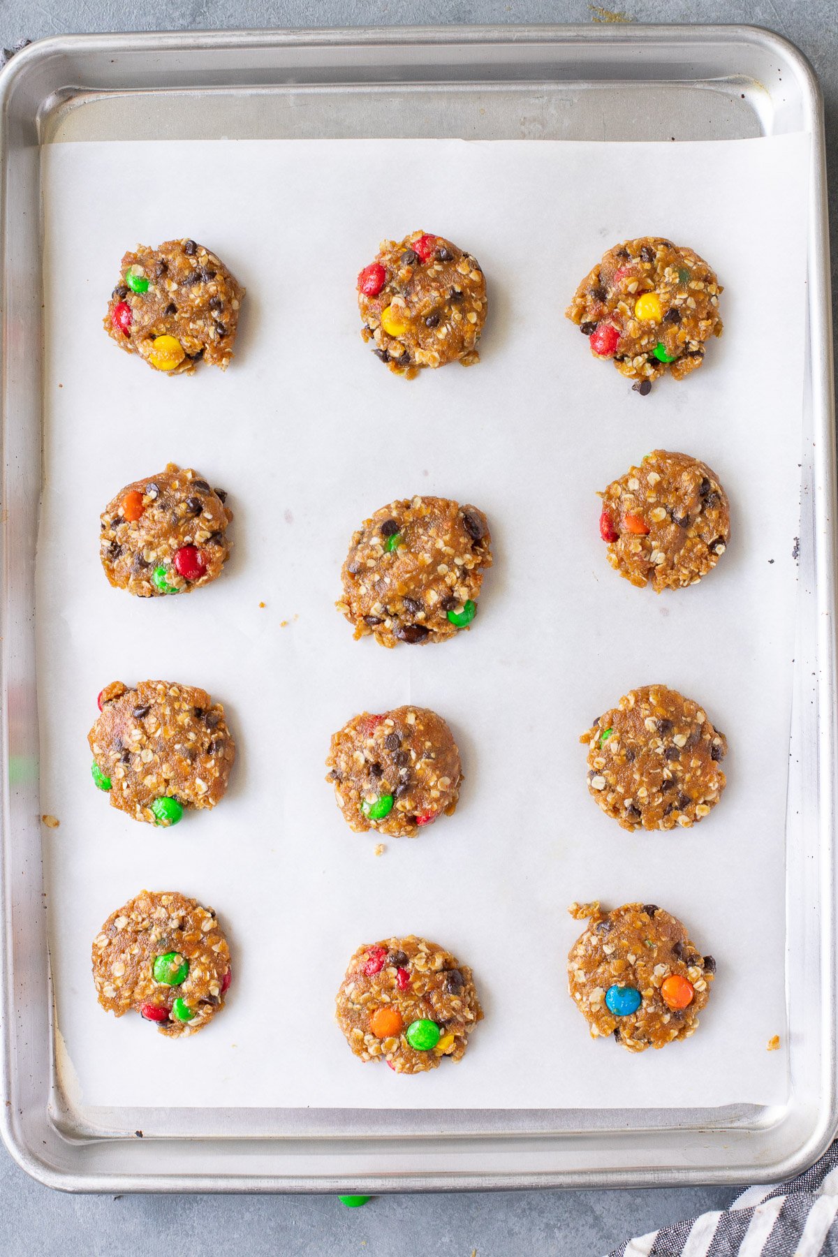 Healthy Monster Cookies on a parchment lined baking sheet before baking