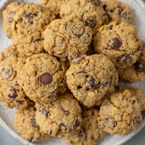 Healthy Oatmeal Chocolate Chip Cookies on a white plate on a grey counter