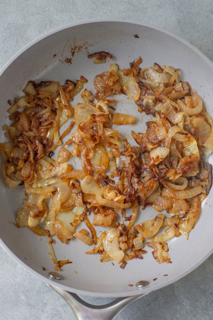 A saute pan with caramelized onions for healthy onion dip