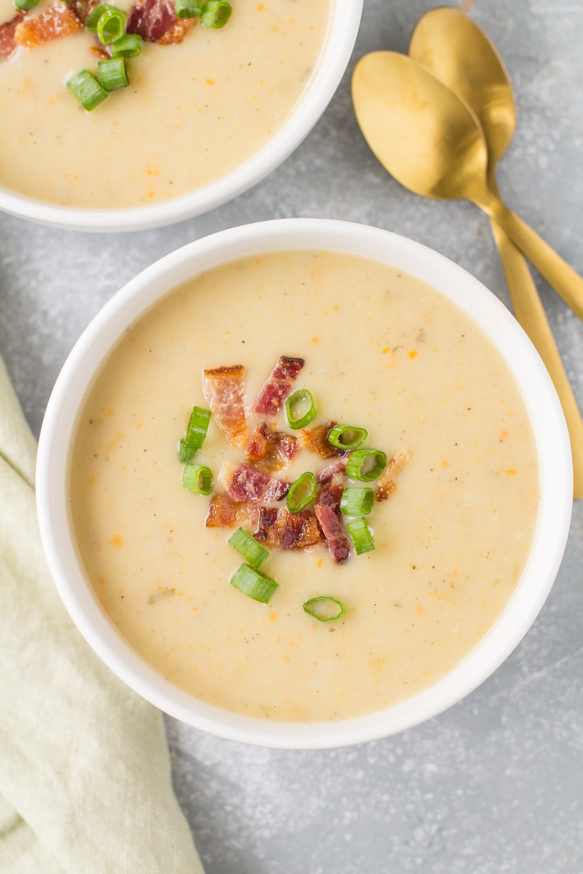 Healthy Potato Soup in a white bowl on a grey background