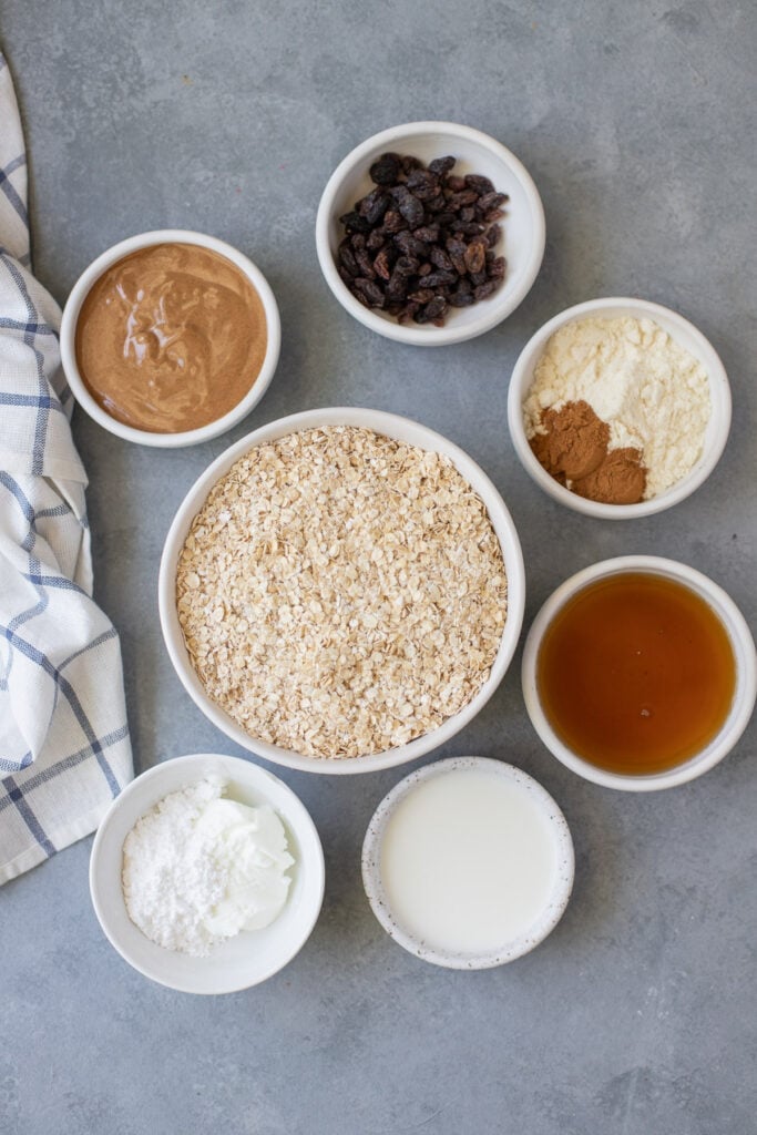 Ingredients for the Best Oatmeal Raisin Bars in small white bowls on a grey background