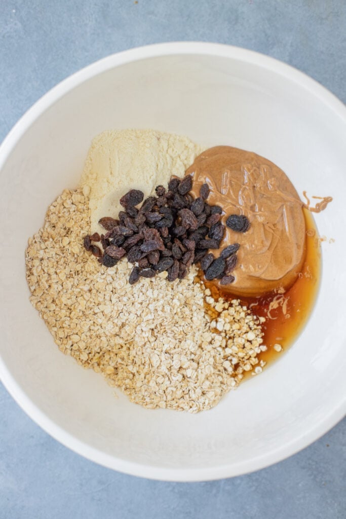Ingredients for healthy protein bars in a big bowl before being mixed together