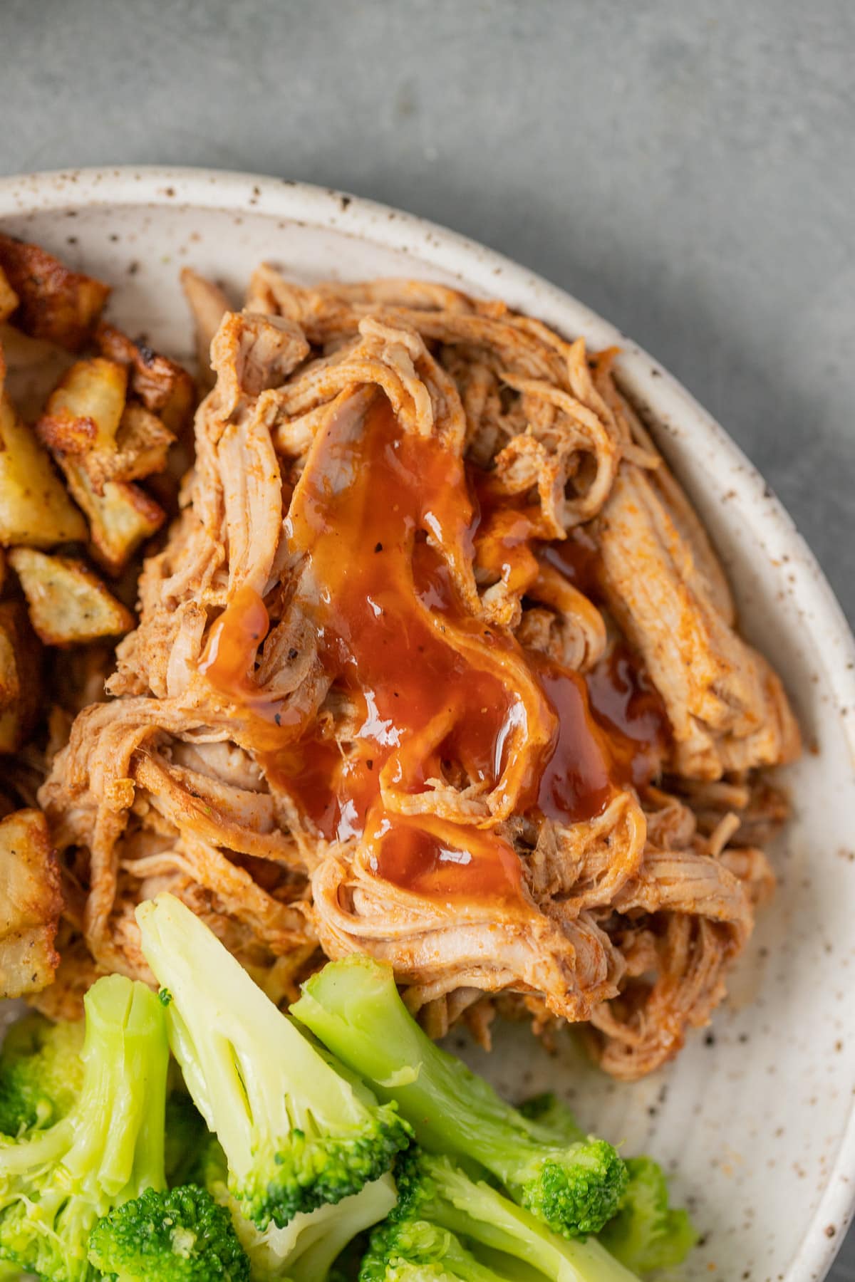 A close up of Healthy Crockpot Pulled Pork on a white dish