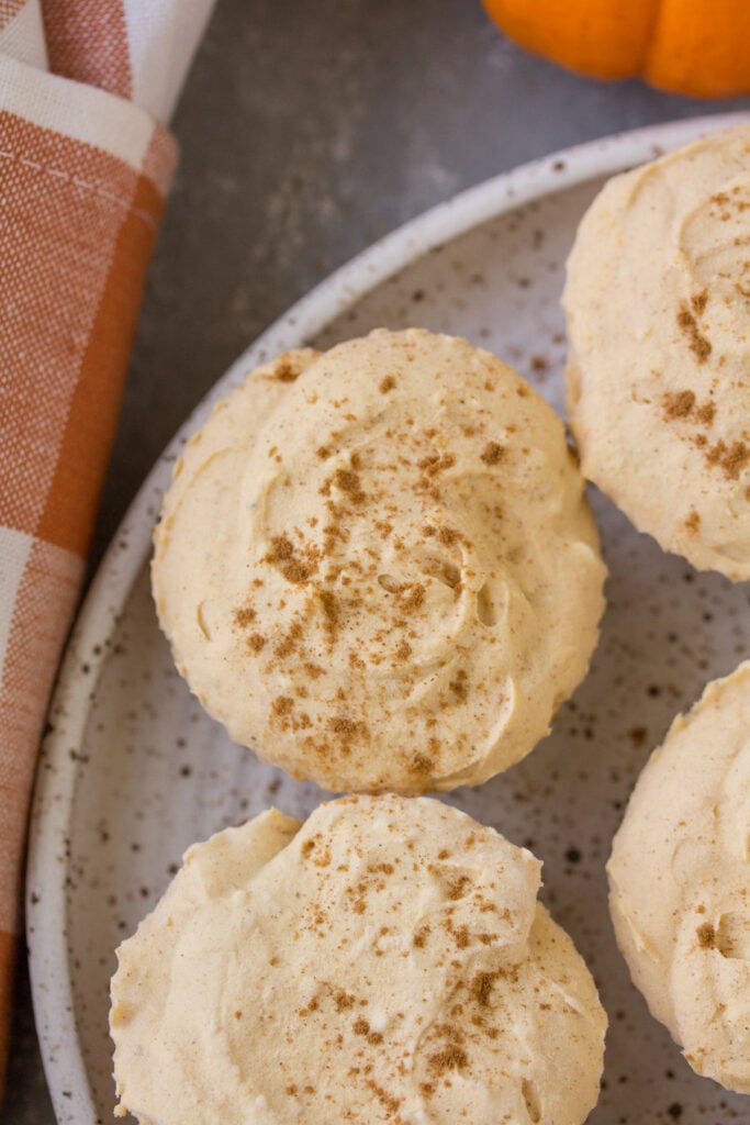 A close up of Healthy Pumpkin Cheesecakes on a white speckled plate