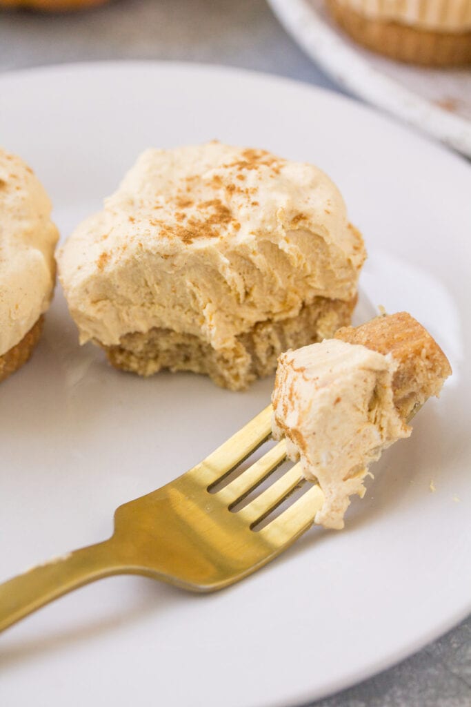 A healthy pumpkin cheesecake with a bite taken out of it.