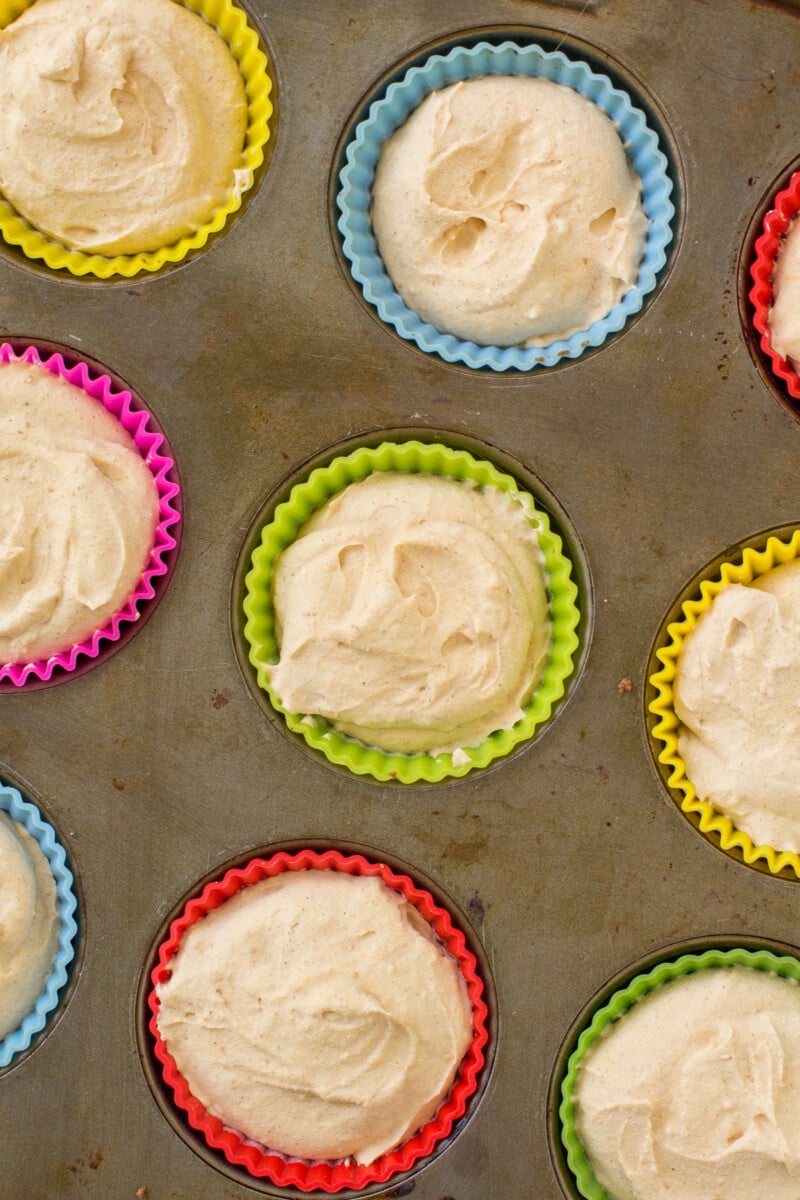 Healthy pumpkin cheesecakes in silicone muffin tins before baking.