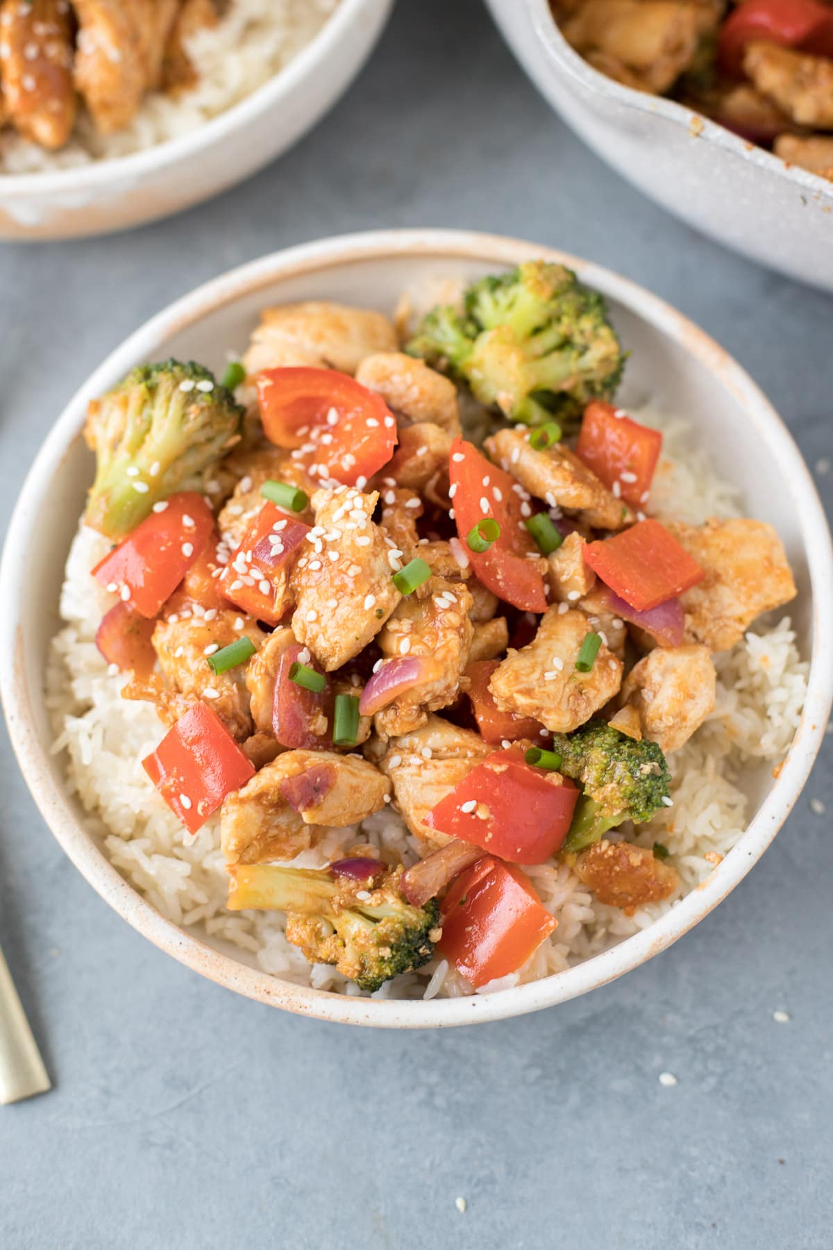 Healthy Sweet & Sour Chicken in a white bowl on a grey background