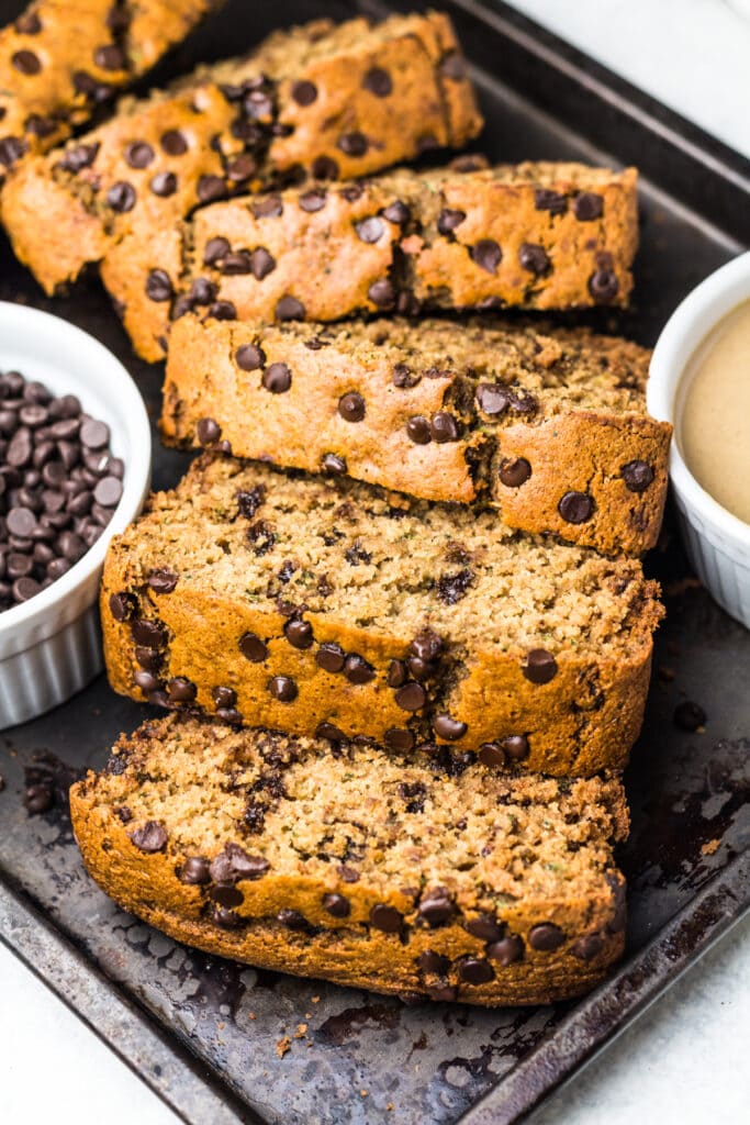 Slices of skinny zucchini bread on a metal tray