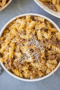A close up of a bowl of homemade hamburger helper on a grey background
