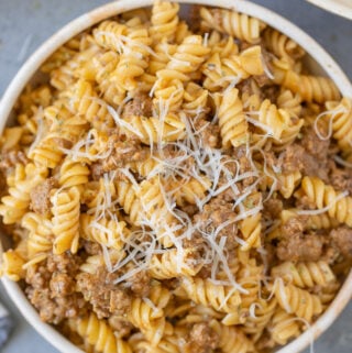 A close up of a bowl of homemade hamburger helper on a grey background