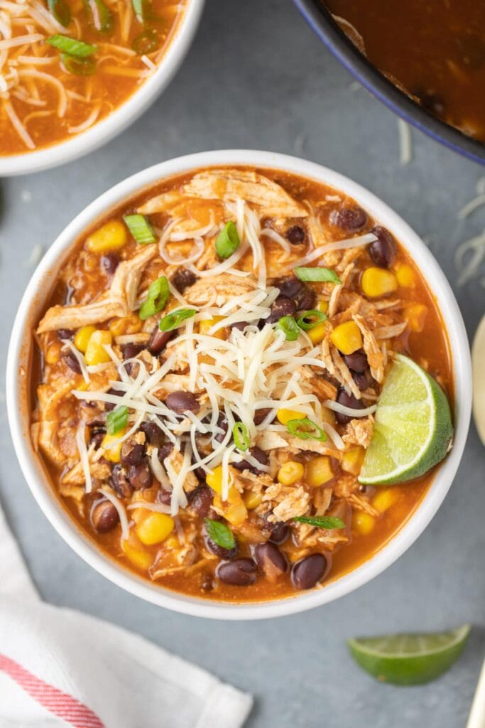 A close up of a bowl of chicken taco soup before it's been added to the freezer.