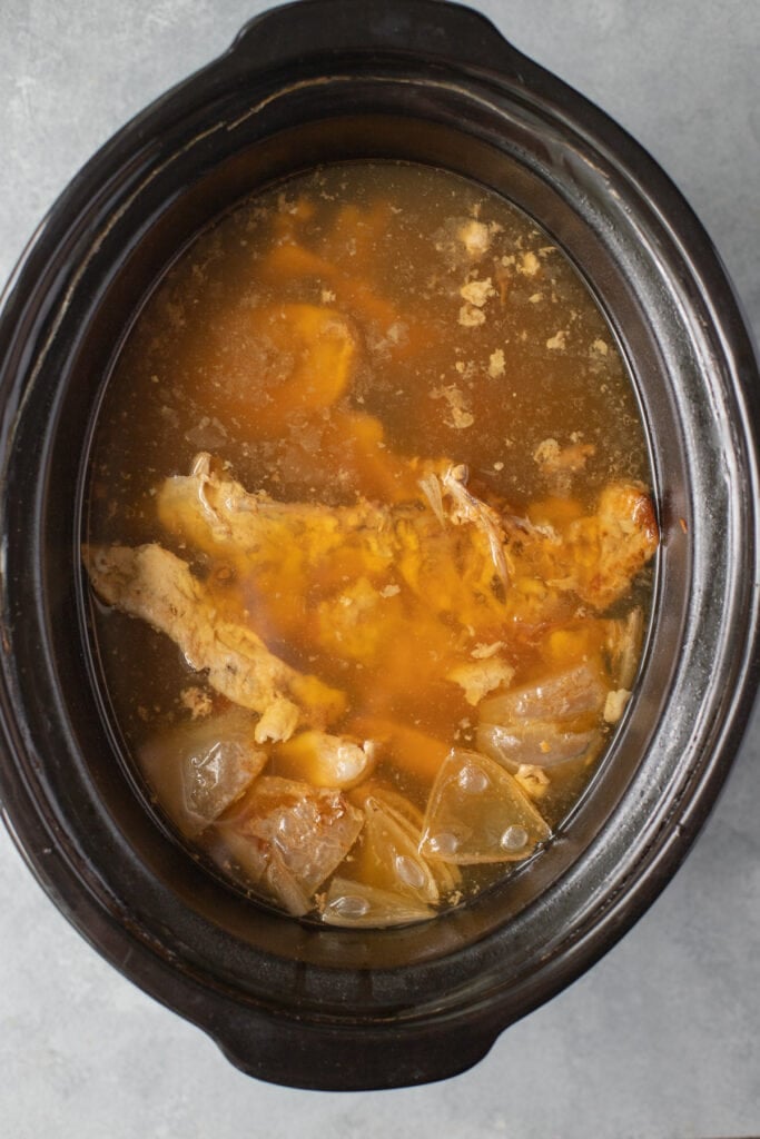 an overhead of bone broth in a crockpot after being cooked