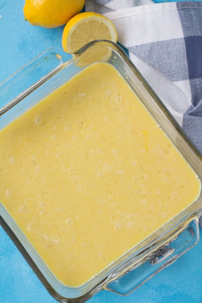 healthy lemon bars in a glass baking dish before being baked