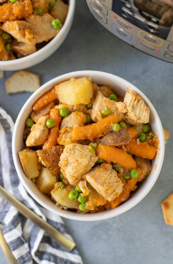 An overhead shot of instant pot chicken stew on a grey background