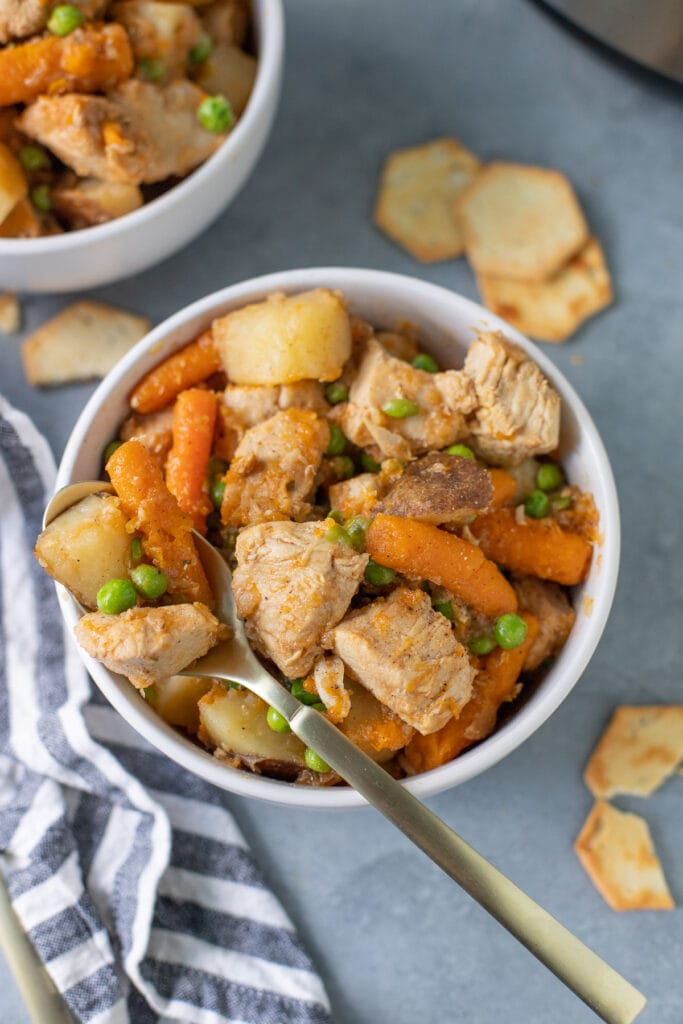 An overhead shot of instant pot chicken stew on a grey background