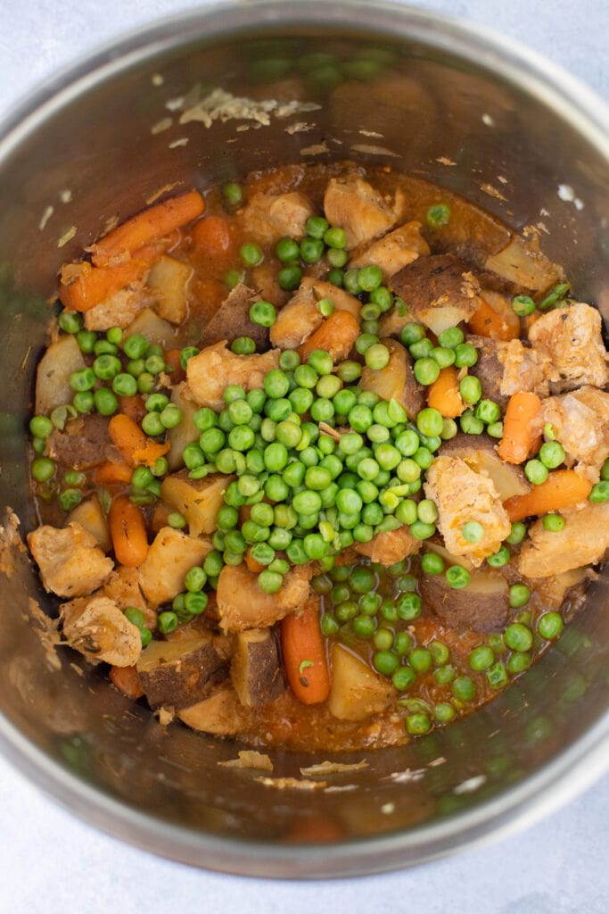 Ingredients for Instant Pot Chicken Stew in the Instant Pot after cooking with peas added