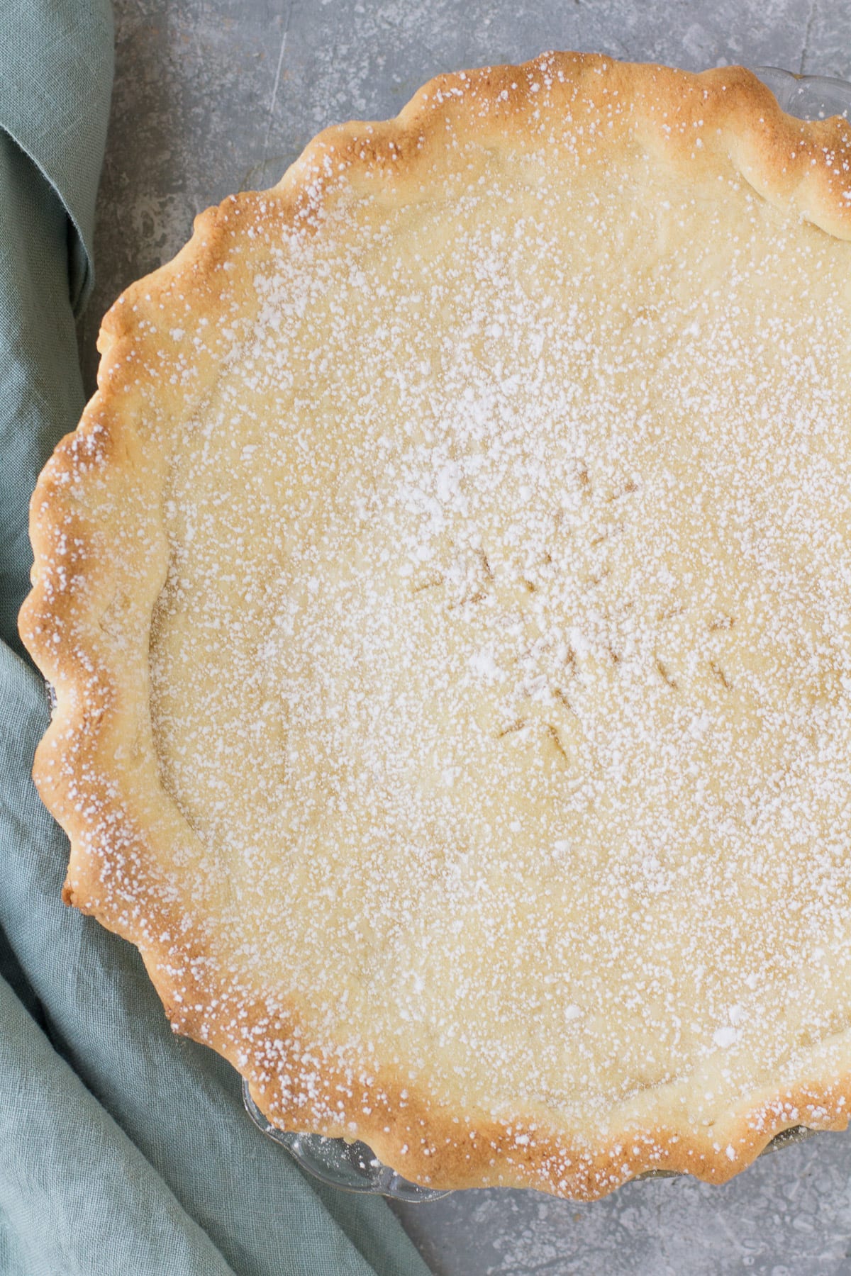 An overhead shot of an Italian Cream Pie on a grey background