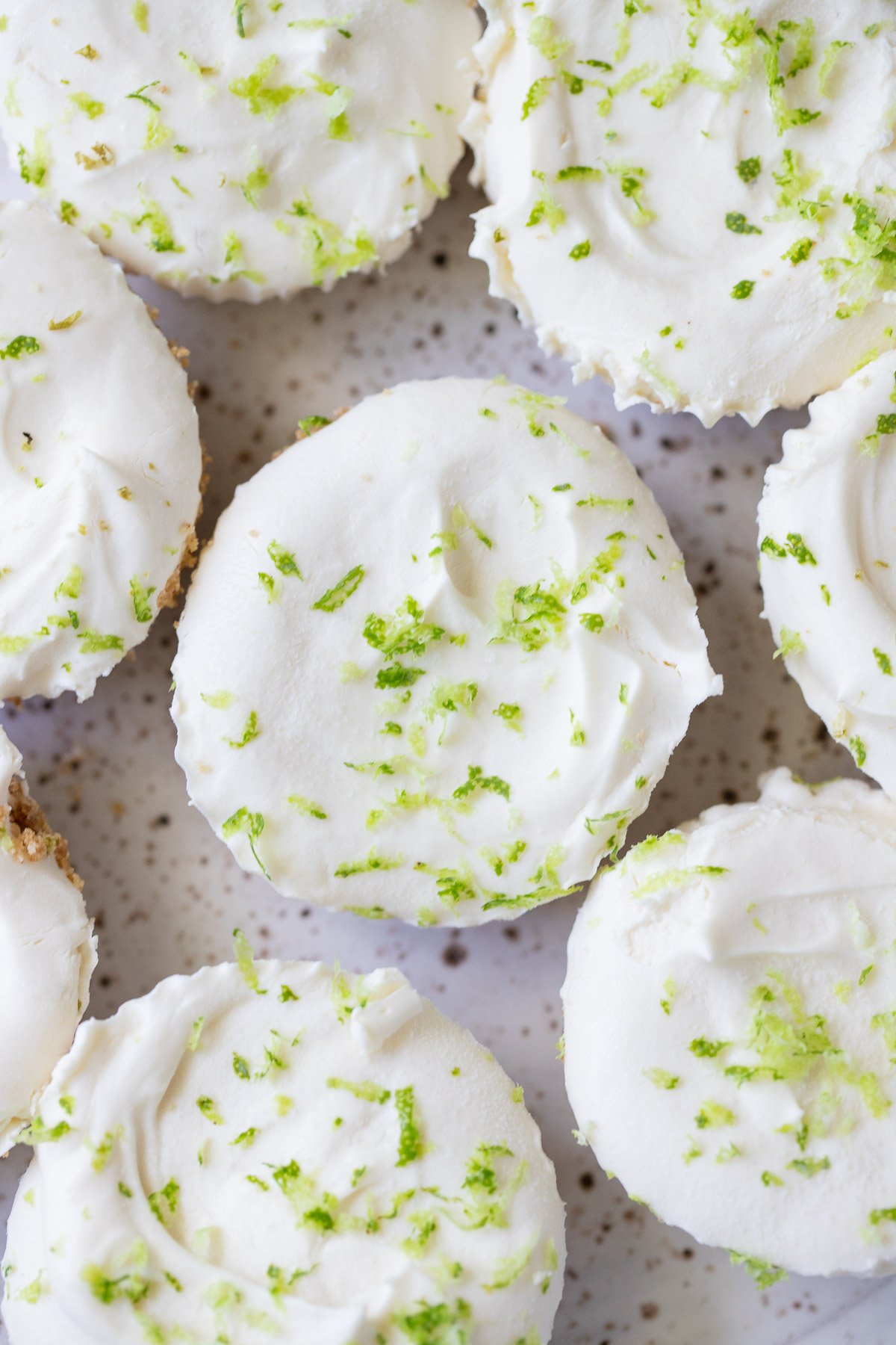 An overhead shot of a plate of key lime cheesecakes