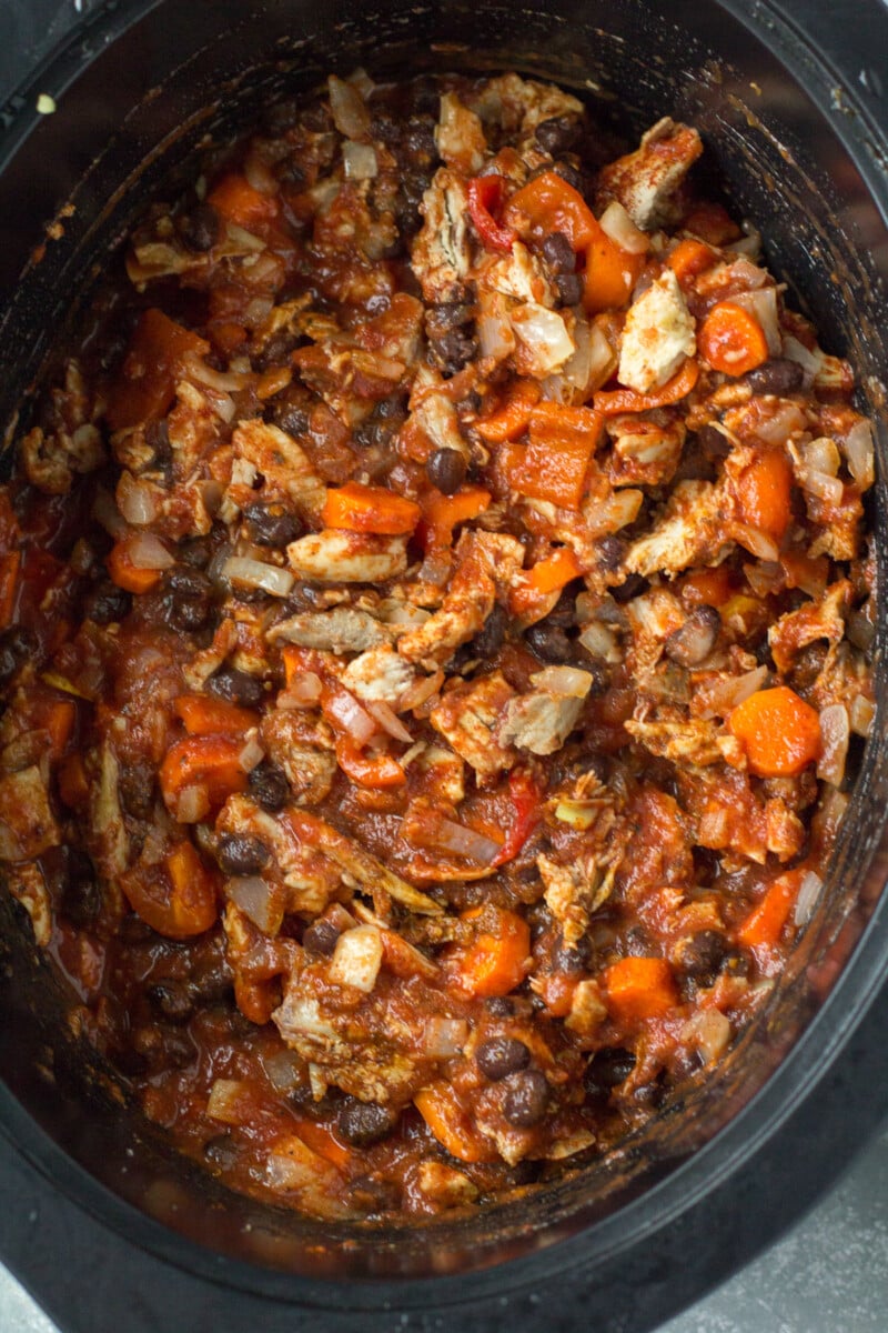 Leftover turkey chili stirred together uncooked in a crockpot base.