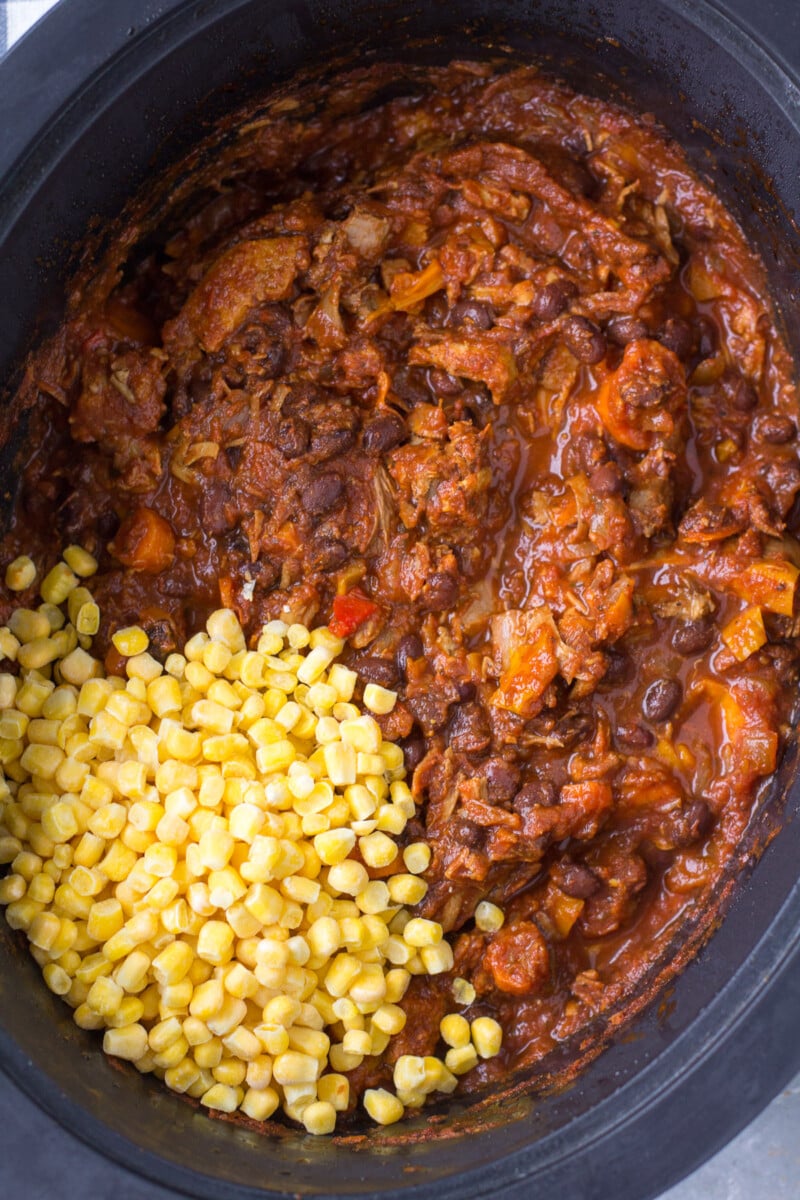 Frozen corn added to a crockpot base of leftover turkey chili before stirring in.