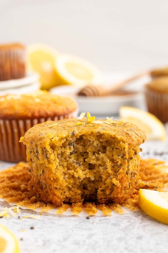 A bite taken out of a Lemon Chia Muffin with more in the background.