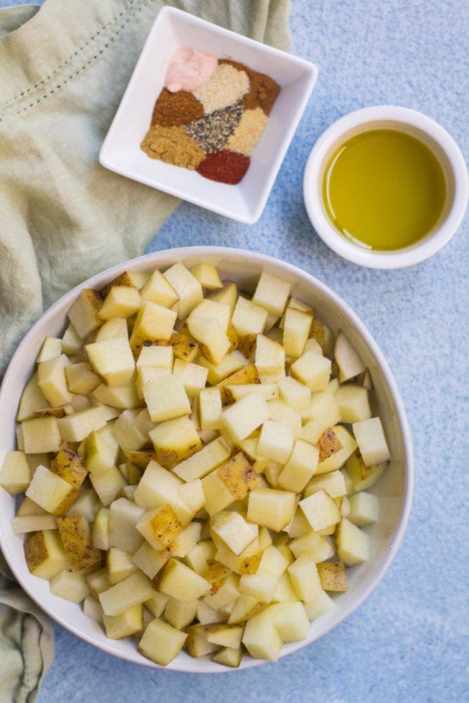 ingredients to make mexican potatoes on a blue background