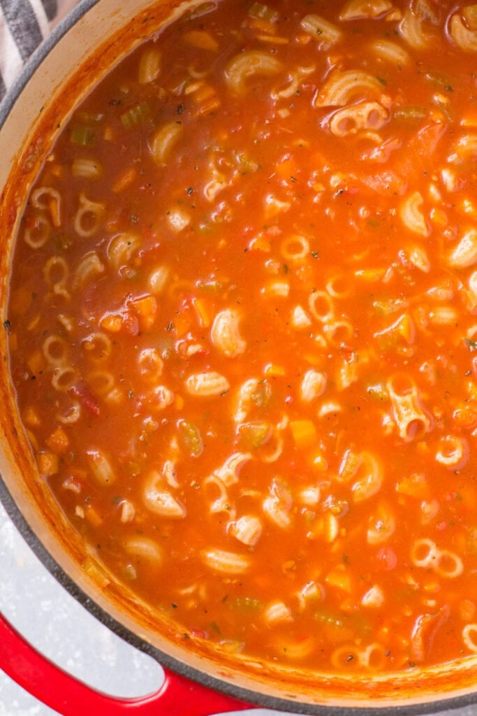 Cooked minestrone soup recipe in a dutch oven.