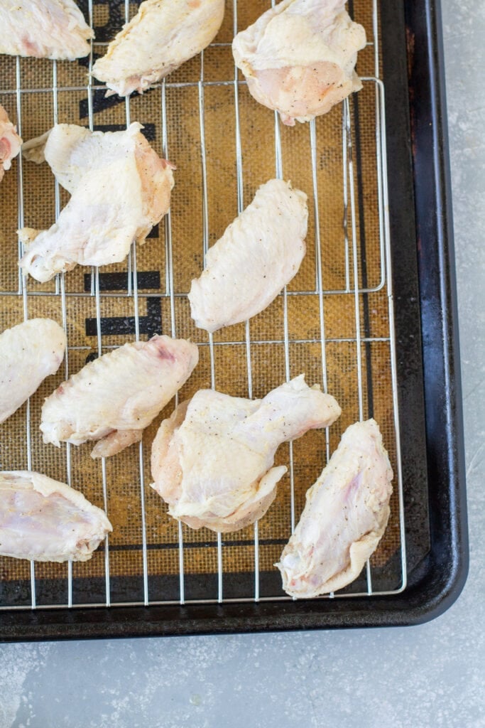 Crispy Parmesan Chicken Wings being baked on a baking sheet