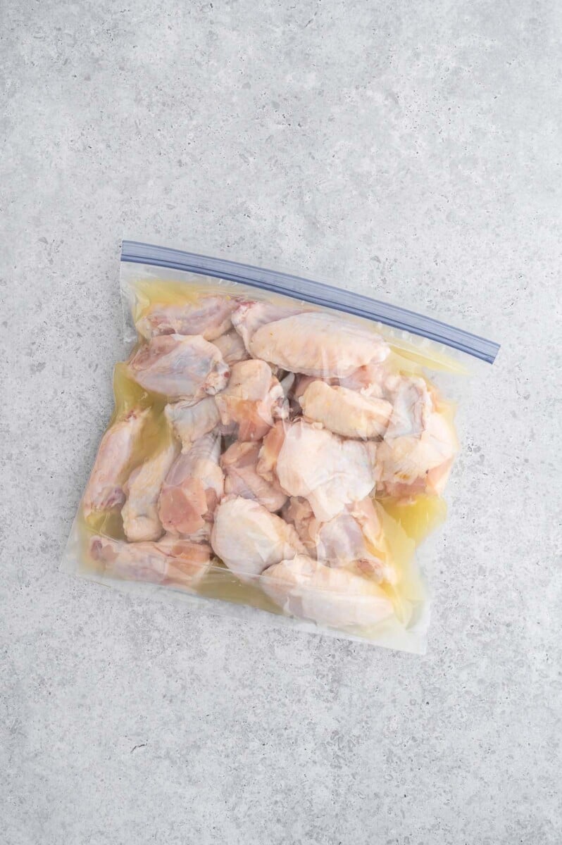 Chicken wings marinating in pickle juice in a ziploc bag.