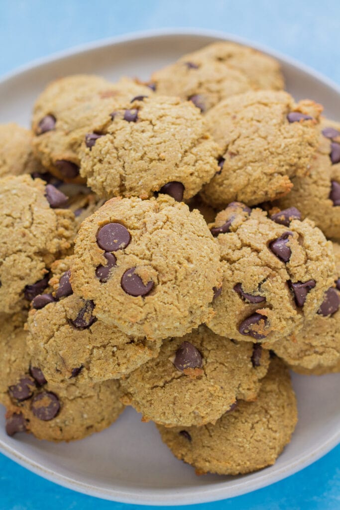 A plate full of healthy protein cookies on a bright blue background