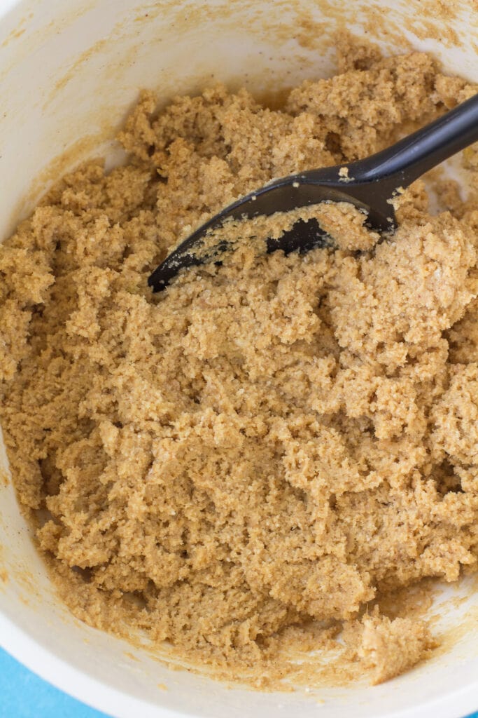 Dough for protein cookies being mixed together with a black spatula