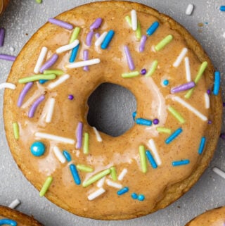 A hand holding up Clean Eating Protein Donuts