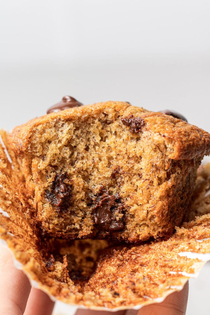 a healthy banana protein muffin with a bite taken out of it