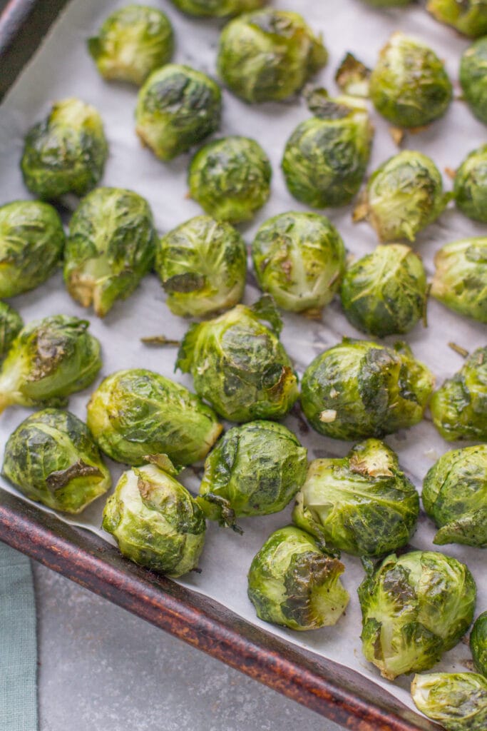 Roasted Brussels Sprouts on a parchment lined sheet pan