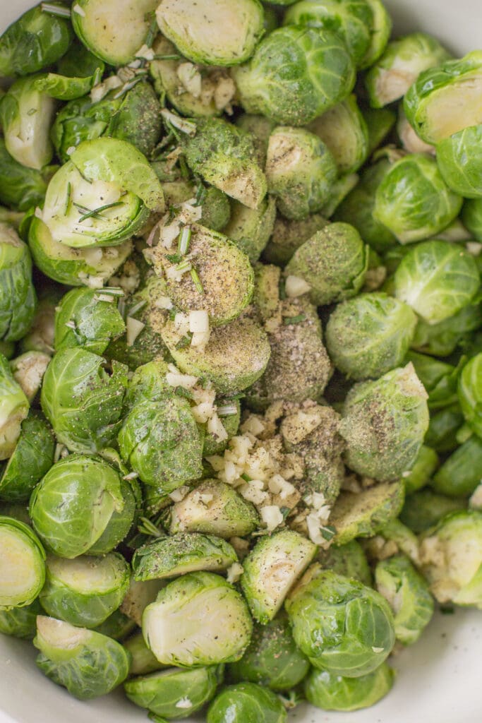 An overhead of brussels sprouts before being roasted in a bowl