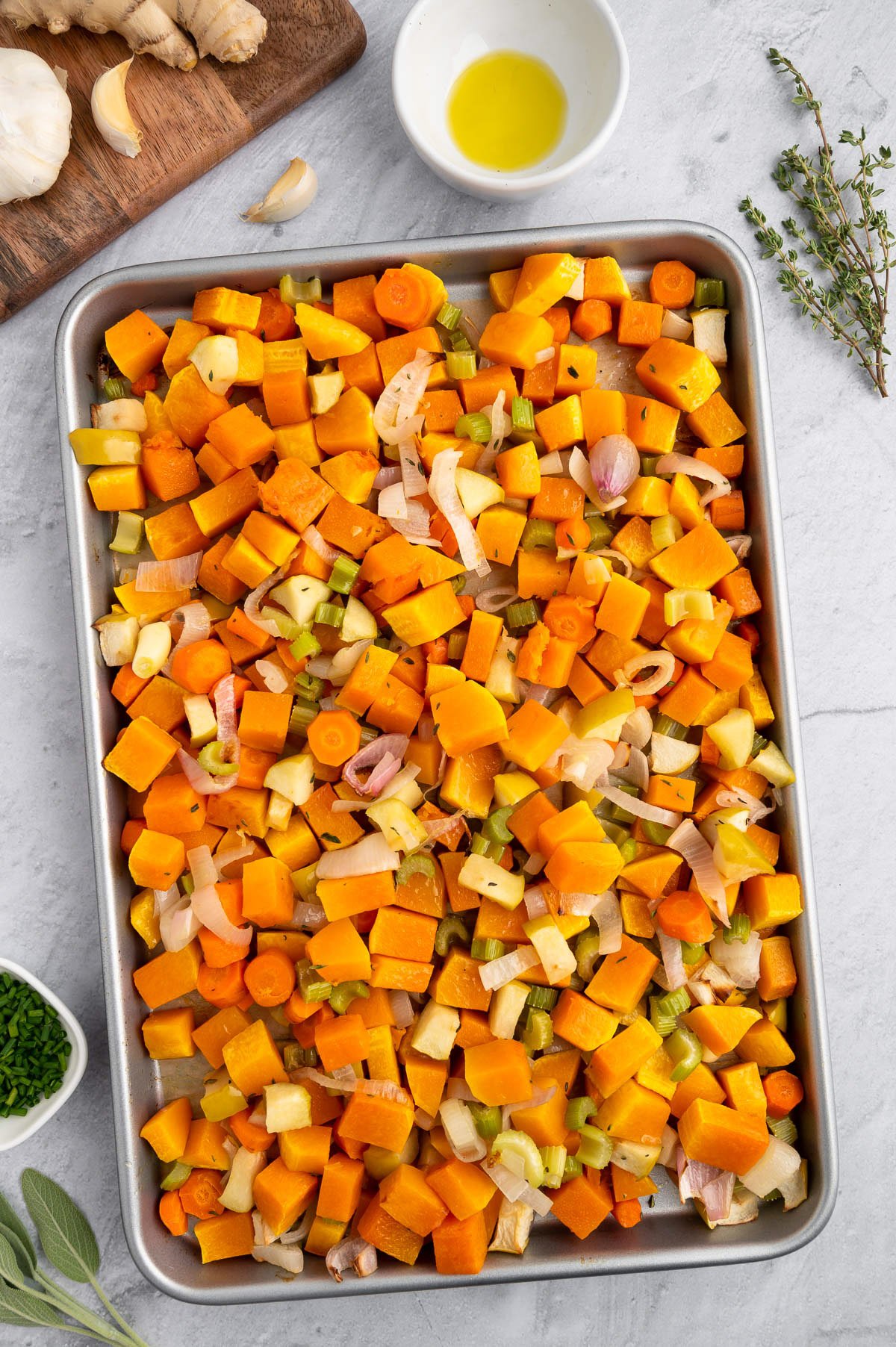 Vegetables for butternut squash soup on a baking sheet after roasting