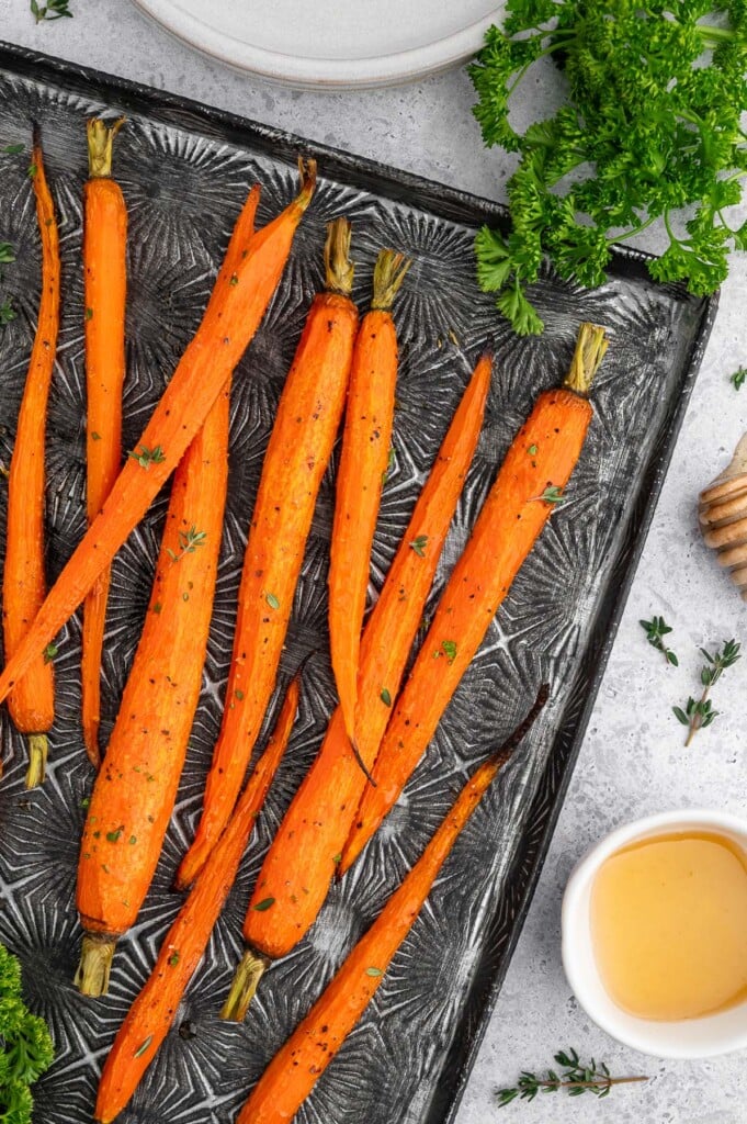 Honey Roasted Carrots on a black baking sheet.