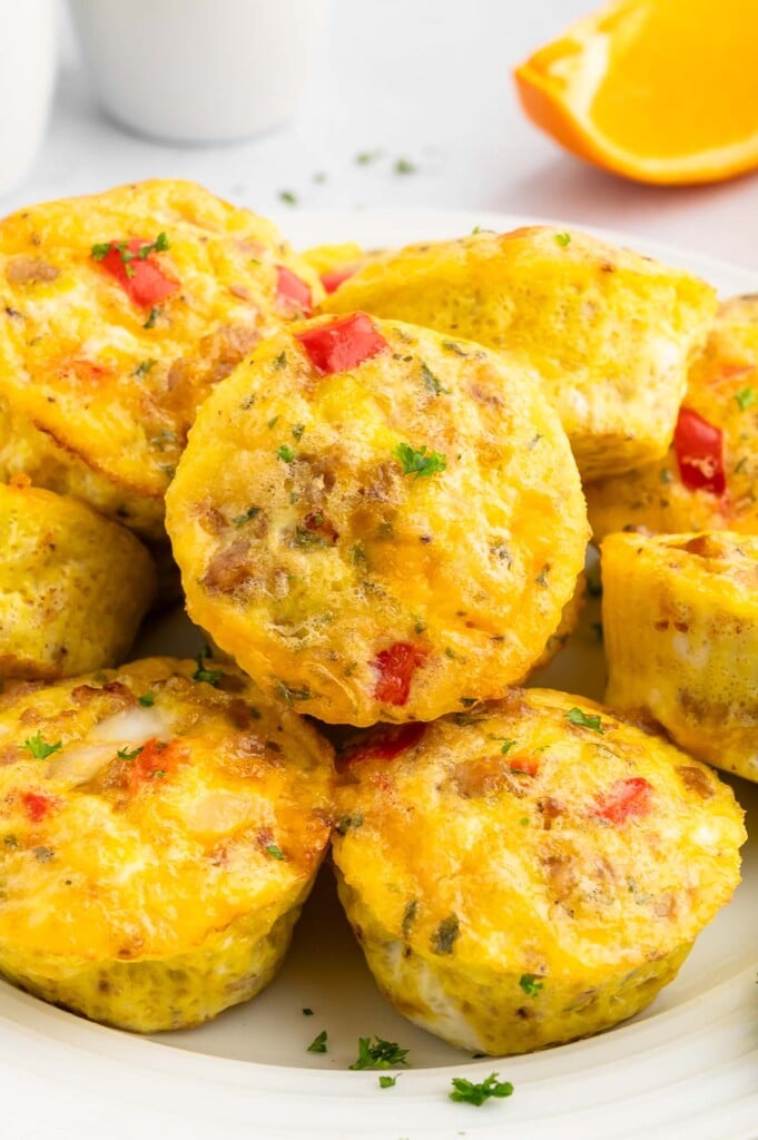 Egg Sausage Muffin cups piled on a white plate.