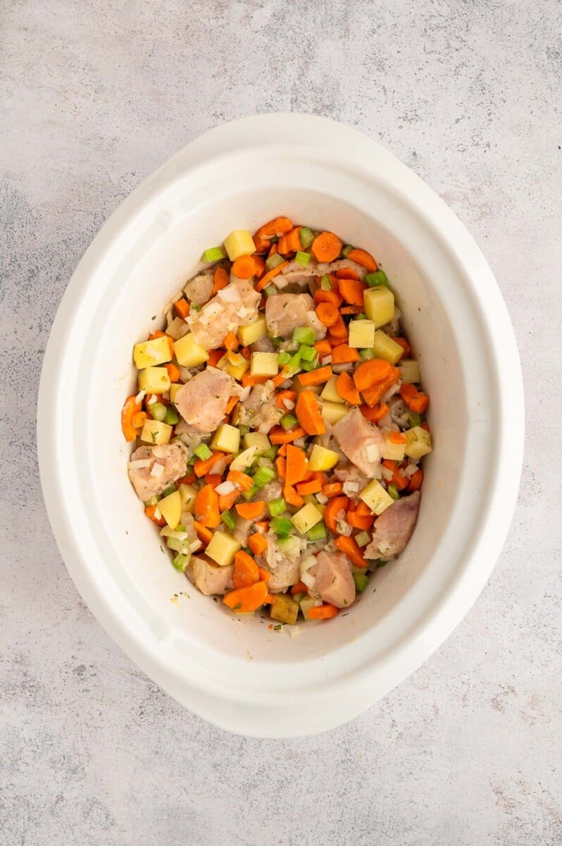 crockpot filled with ingredients for slow cooker chicken stew before being cooked