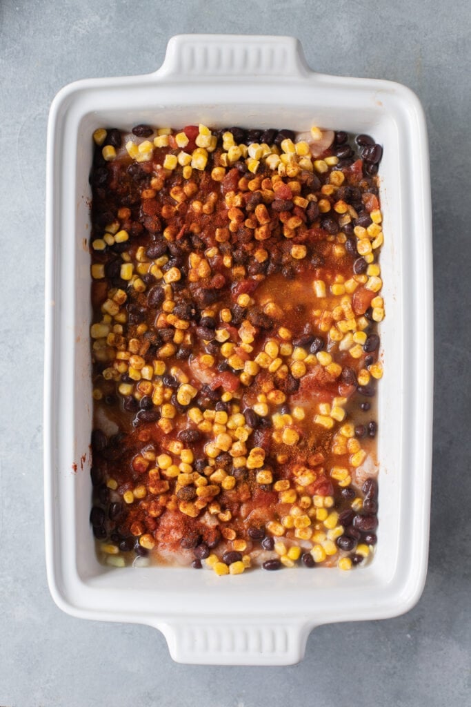 Ingredients for mexican chicken casserole in a casserole dish mixed together, but not cooked