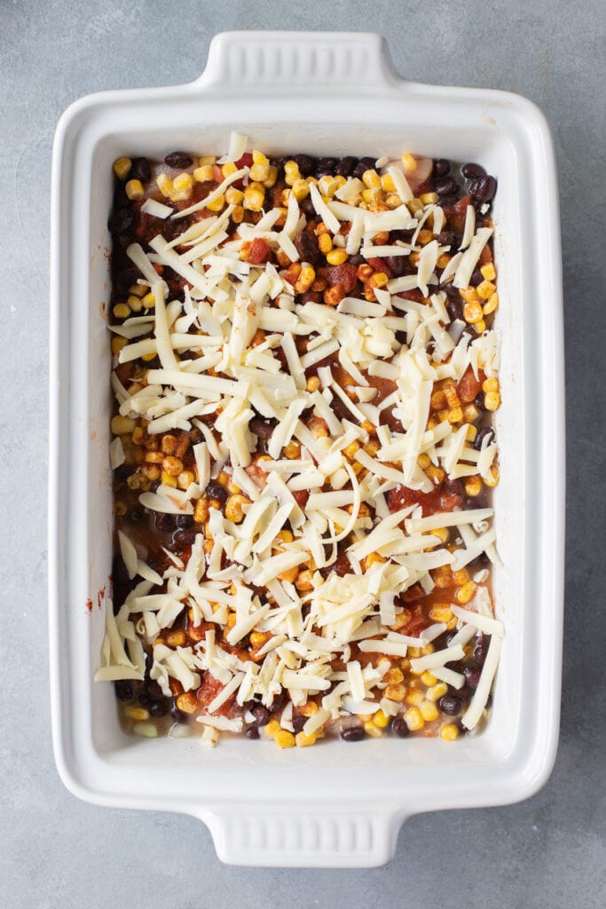 Mexican chicken casserole topped with cheddar cheese