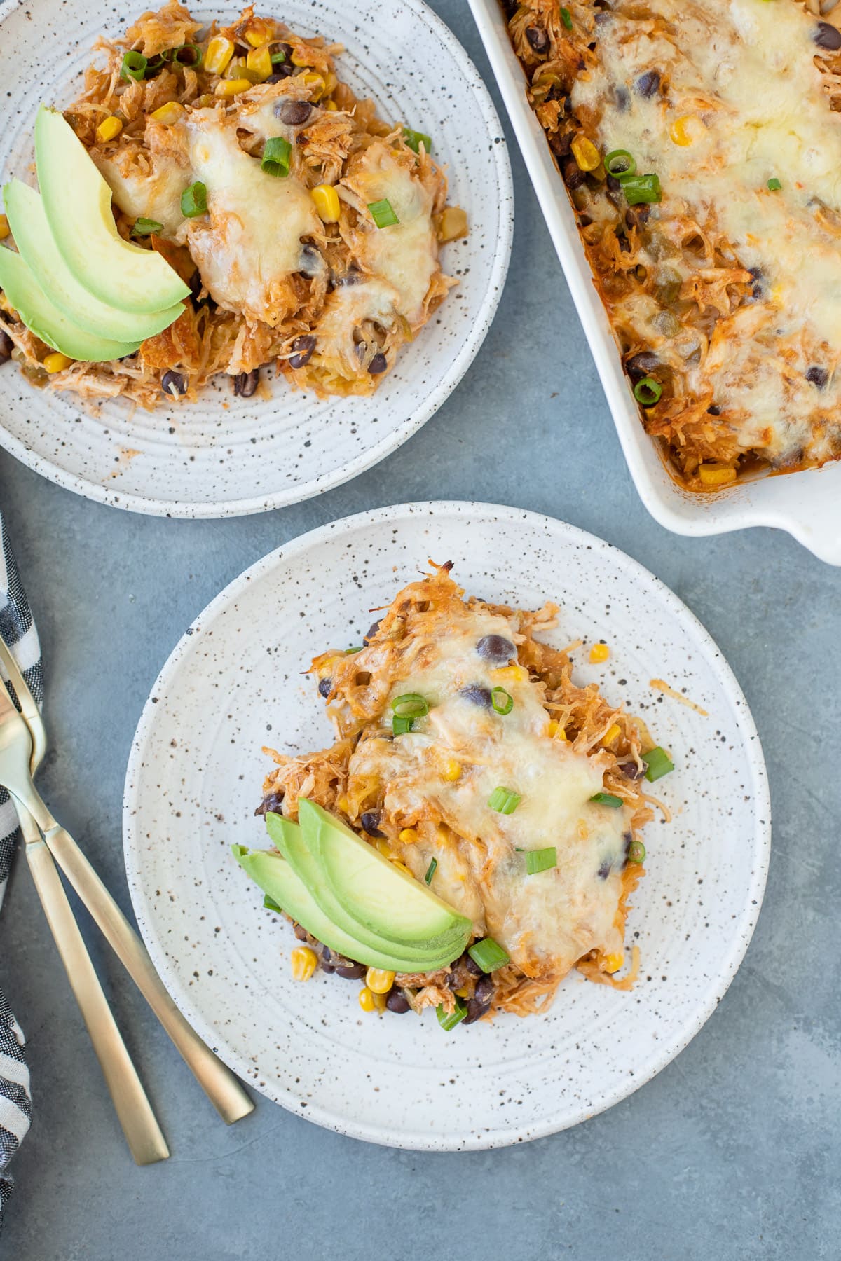 Spaghetti Squash Casserole on a white plate with a second dish and casserole dish off to the side