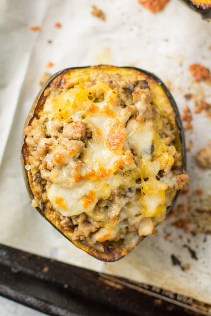 Stuffed Acorn Squash on a parchment lined baking sheet
