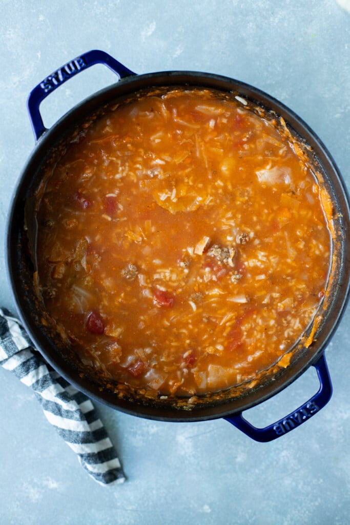 Cabbage Roll Soup in a dutch oven on a grey background