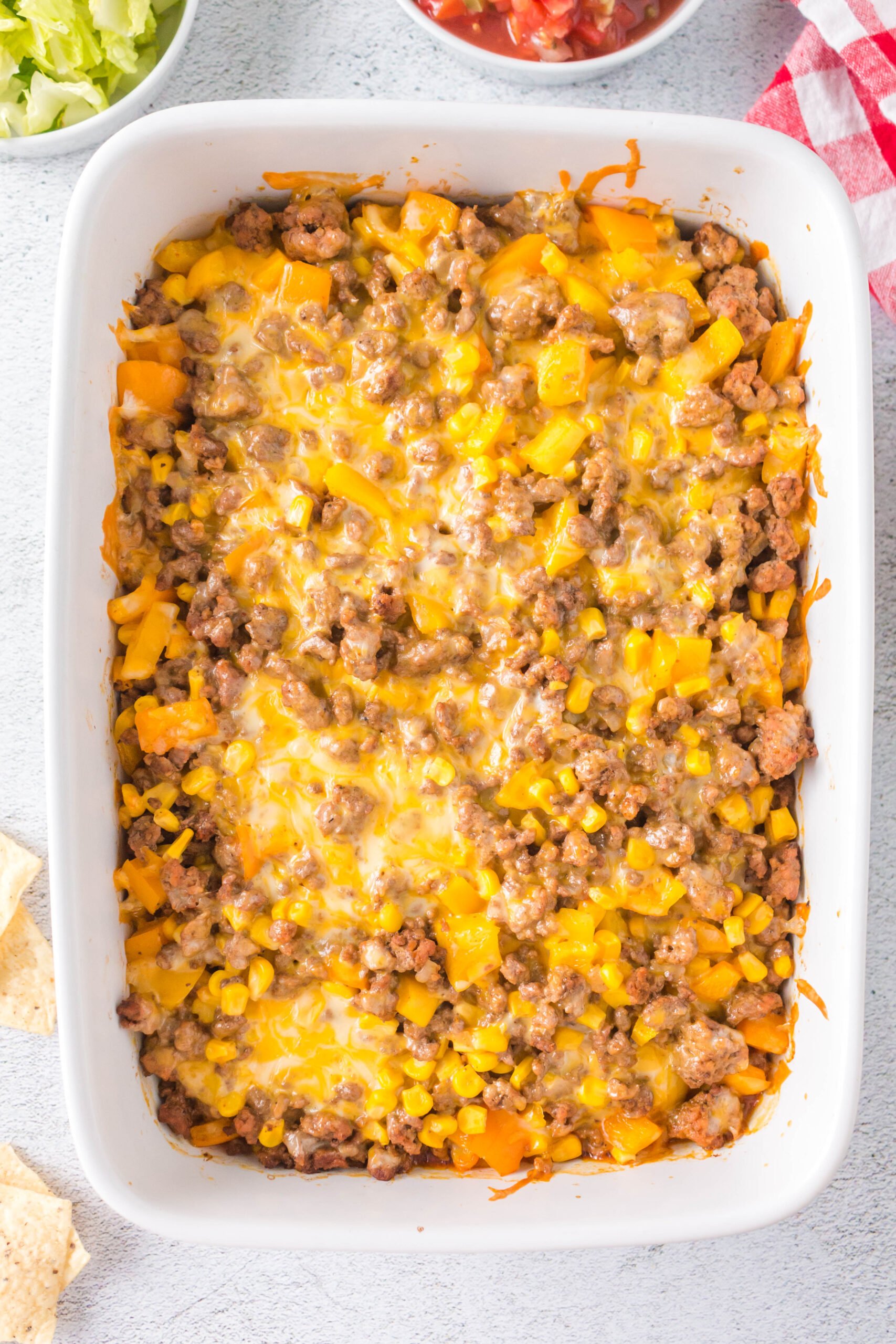 An overhead shot of taco ground beef casserole in a white dish
